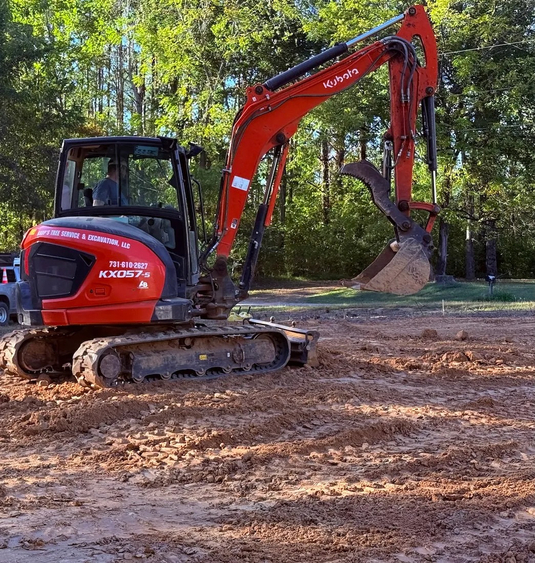 Excavation — excavation contractor Selmer, TN Red excavator performing excavation work for Selmer TN homeowners